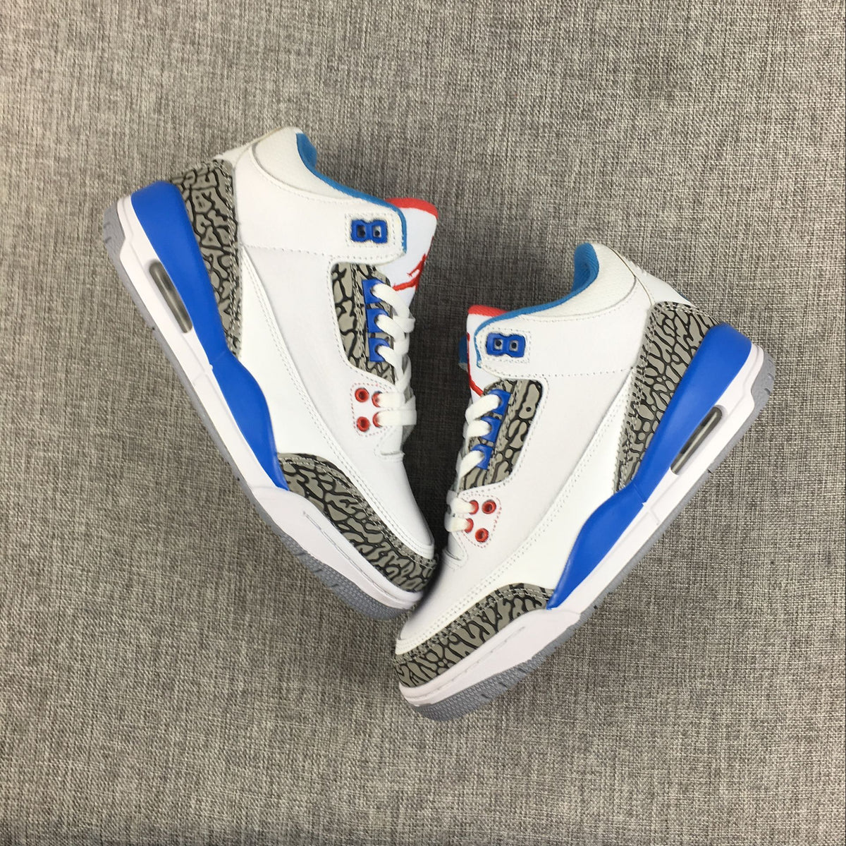 Top-down view of the Air Jordan 3 Retro sneakers arranged toe to toe.