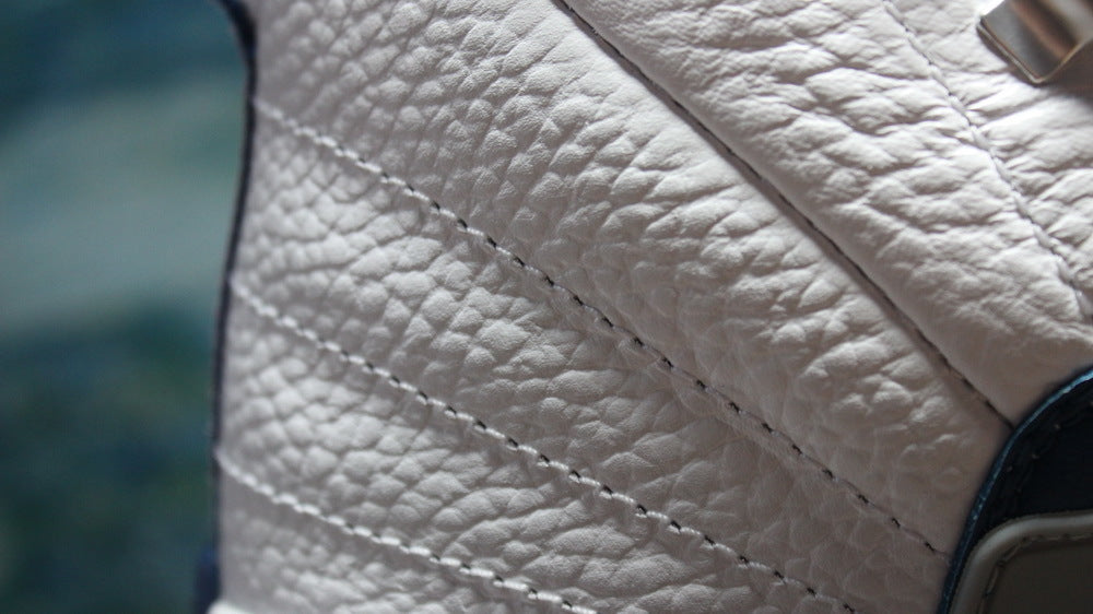 Detailed view of stitched textured white side panels.