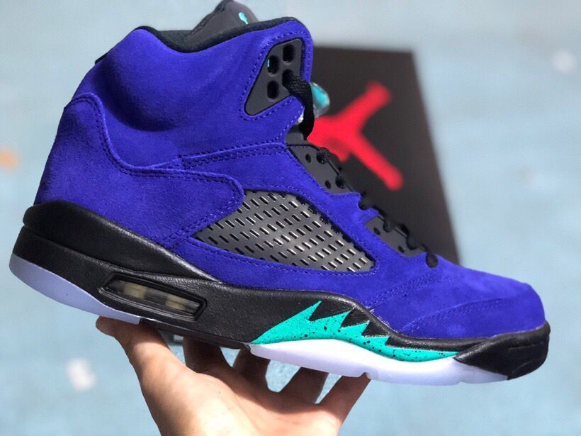 Side view of the purple high-top sneaker with black mesh, turquoise midsole accents, and translucent outsole.