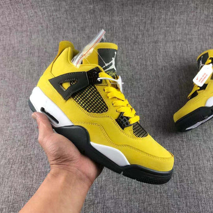 Close-up of a yellow and black high-top sneaker showing the side mesh panel, lace system, white midsole, and black outsole.