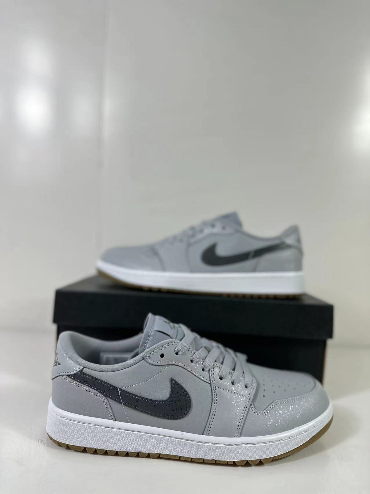 Angled side view of the grey low-top sneaker with dark Swoosh branding.
