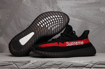 Black sneaker shown beside its outsole, displaying the ribbed dark sole and textured tread.