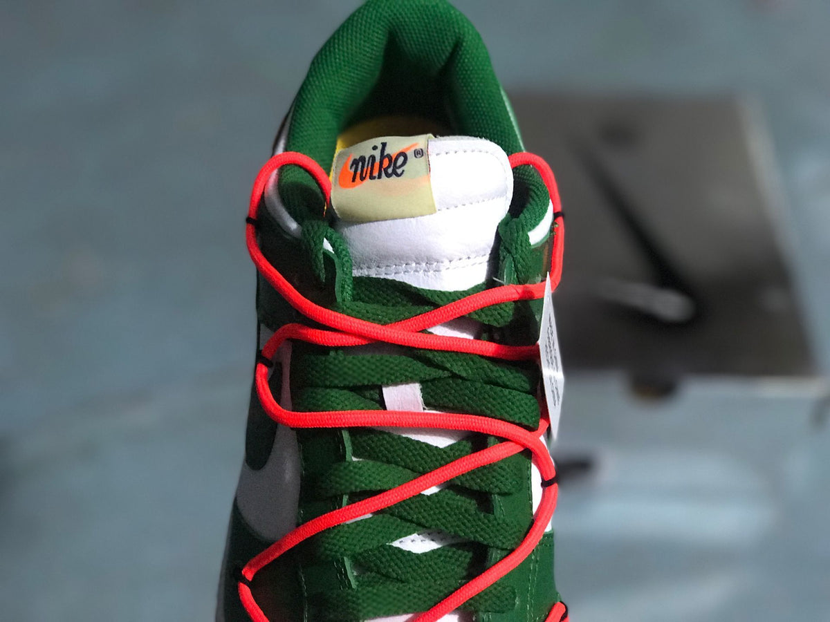 Top-down view of the green tongue, green laces, and bright red cord-style laces.