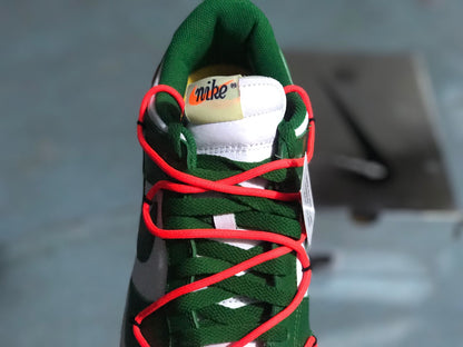 Top-down view of the green tongue, green laces, and bright red cord-style laces.