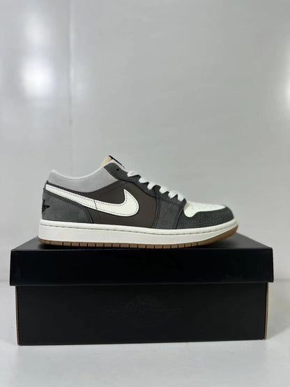Single low-top sneaker shown in side profile with grey collar panels, black overlays and a white Swoosh.