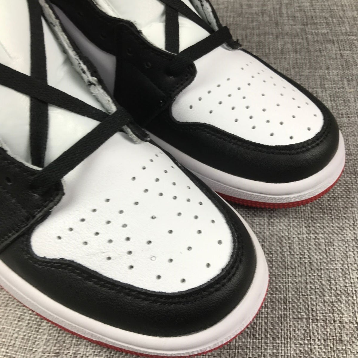 Close-up of perforations on the white toe box and black overlay