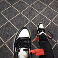 Close-up top view of the black laces, white toe box, and contrasting black trim.