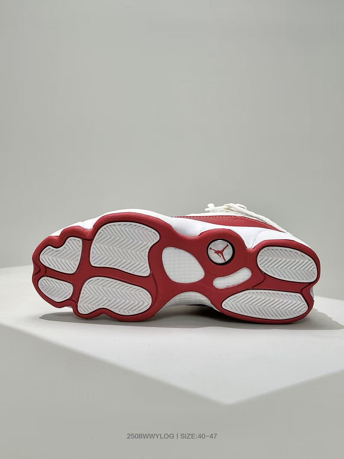 Underside view of the white and red Jordan sneaker showing the segmented outsole and Jordan logo.