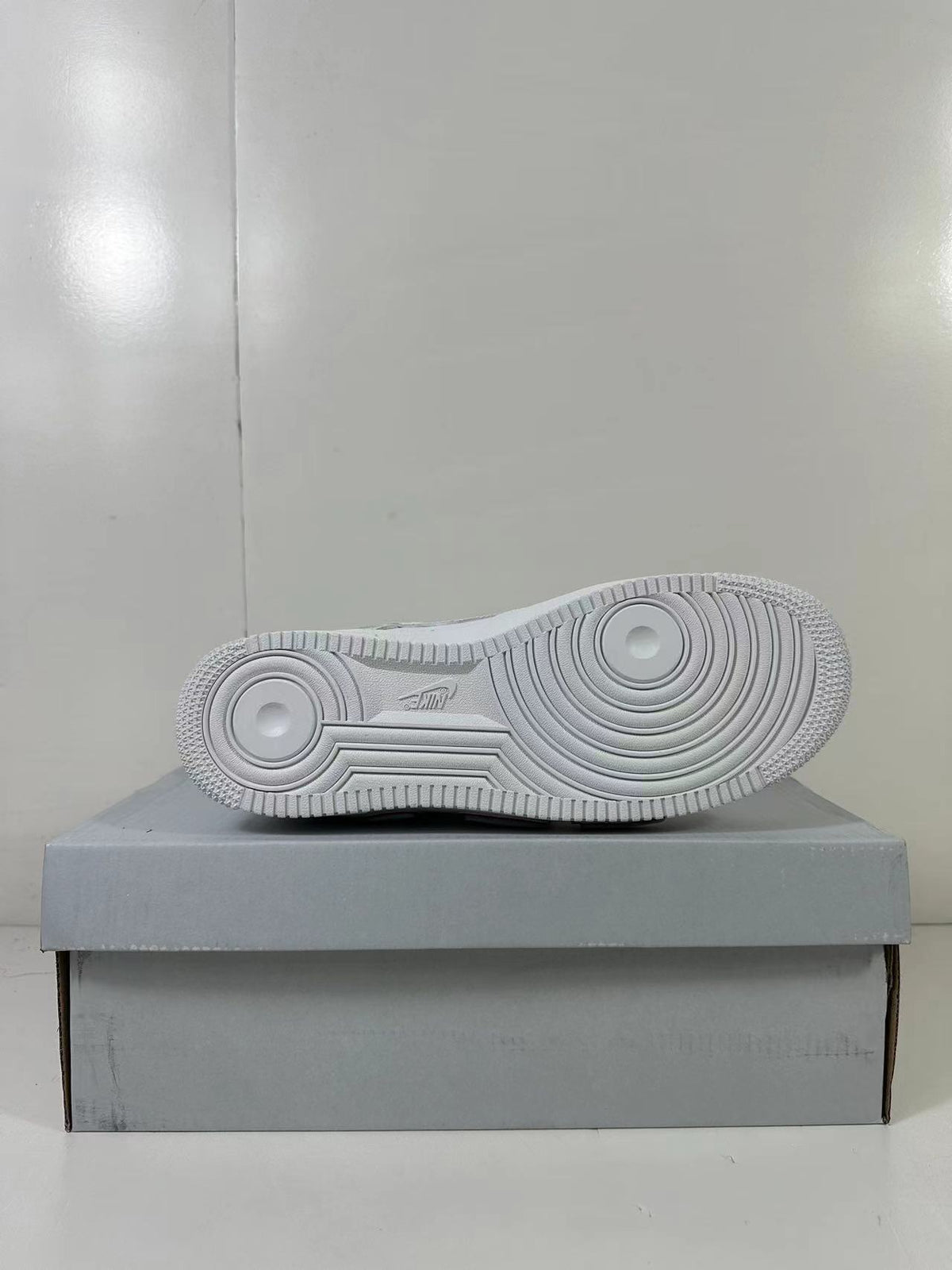 Underside view showing the white rubber outsole with concentric circular traction patterns.