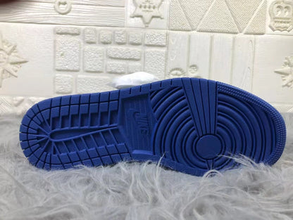 Bottom view of the blue rubber outsole showing circular and linear traction patterns.
