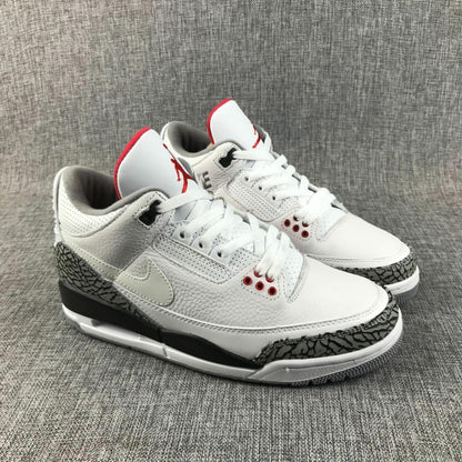 Three-quarter front view of the pair with white laces, red tongue accents, and patterned toe panels.