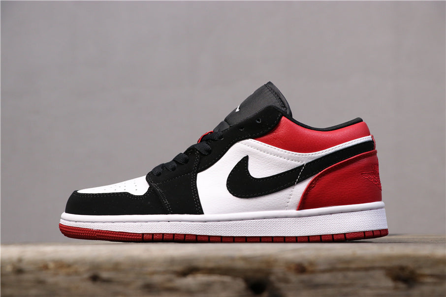 Opposite side profile of the low-top sneaker in black, white, and red.