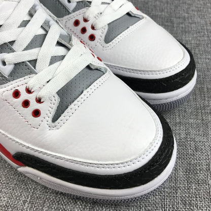 Close-up of the perforated gray lace panel, white toe box, and black textured toe overlay.