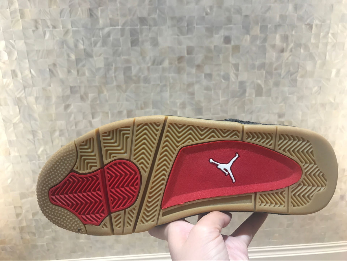 Outsole view showing patterned gum-colored traction and a red central section.