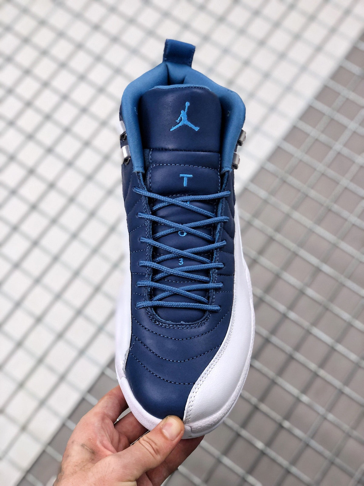 Top view of the indigo Jordan sneaker showing blue laces, padded tongue, and blue Jumpman branding.