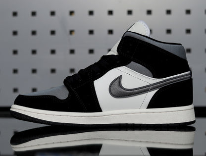 Side profile showing the black and grey Swoosh, white side panel and layered midsole.