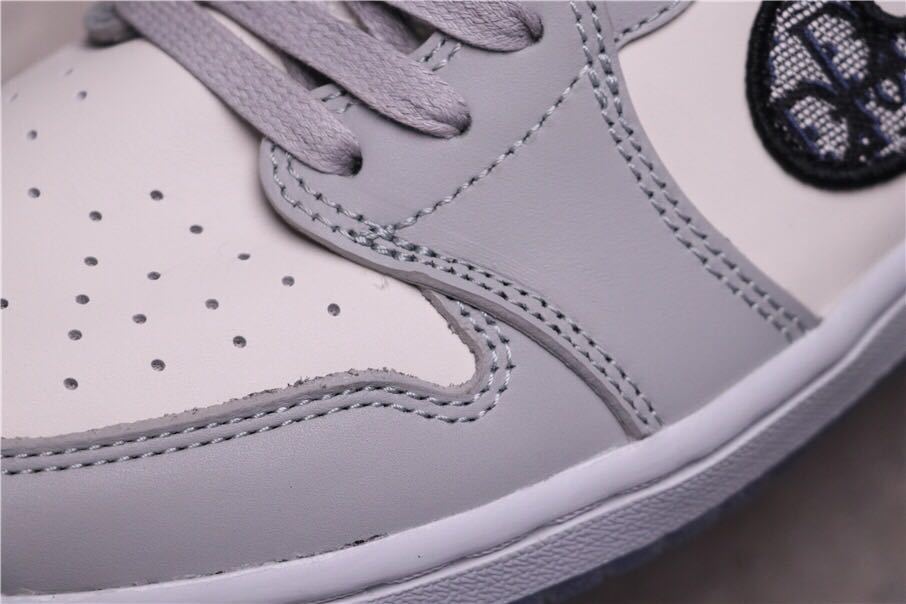Detailed view of the perforated toe box, grey overlays and layered stitching.