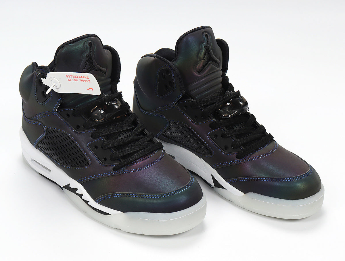 Pair of dark iridescent Jordan 5 Retro sneakers with black laces.