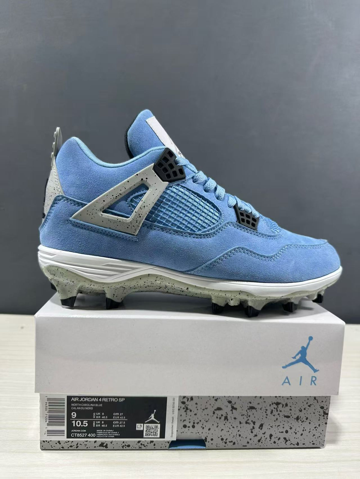 Side view of the sneaker beside its shoebox; the visible label shows Air Jordan 4 Retro SP, style code CT8572-400, and size details.