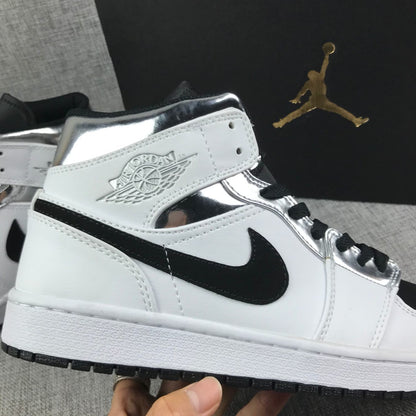 Close-up of the ankle area with the embossed Jordan Wings-style logo, black Swoosh, and metallic silver panels.
