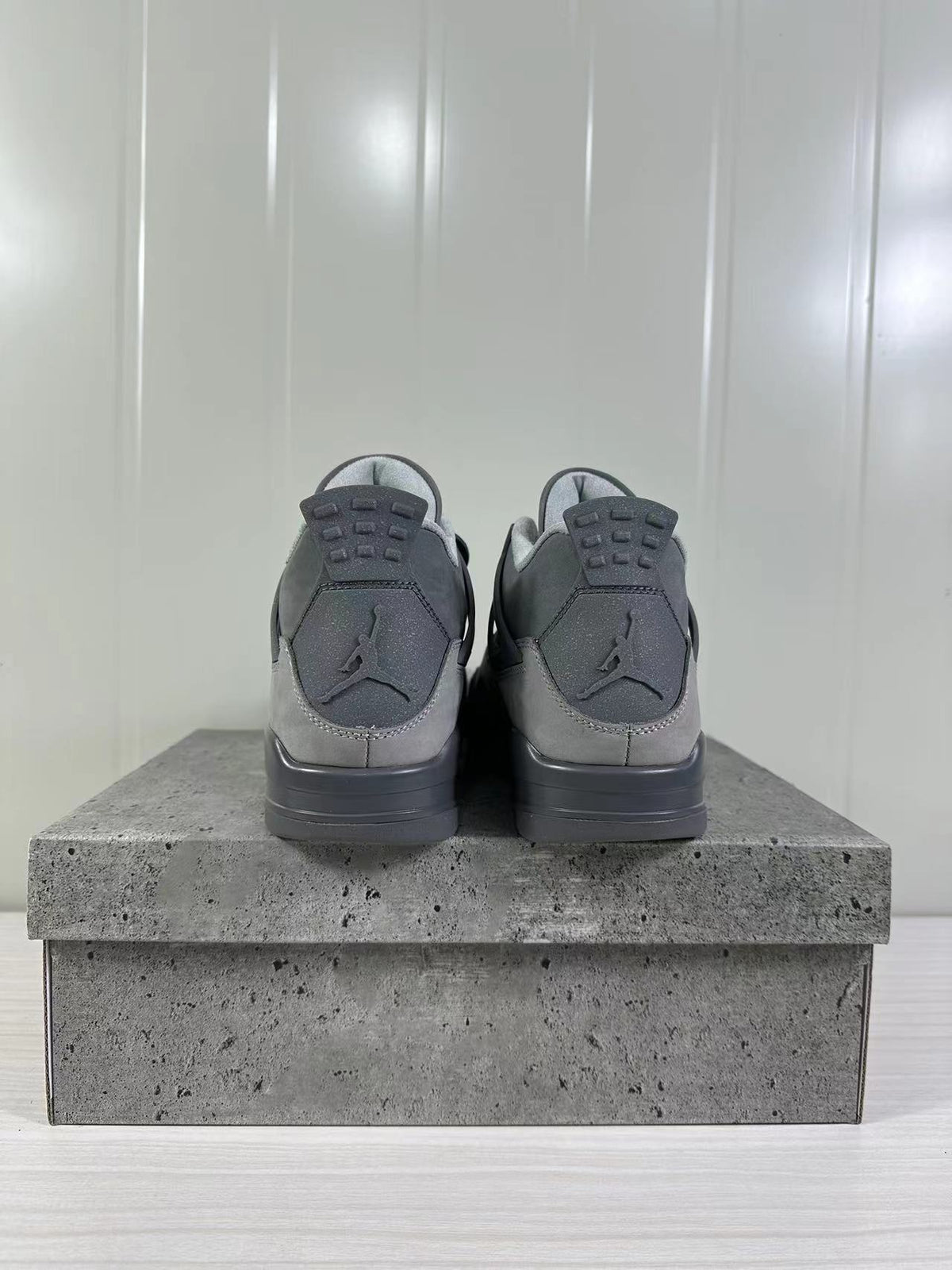 Rear view of the pair showing the tonal Jordan heel logos and layered grey heel panels.