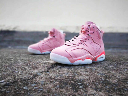 Pair of pink Air Jordan 6 high-top sneakers displayed at an angled front-side view.