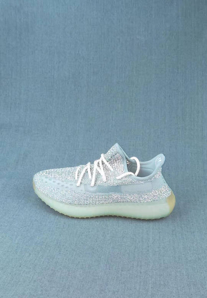 Side profile of a pale icy Yeezy 350 V2 sneaker with translucent sole detailing.