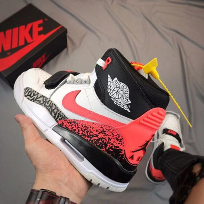 Close angled view of the black collar, Air Jordan winged-ball emblem, red heel panel, and elephant-print detailing.