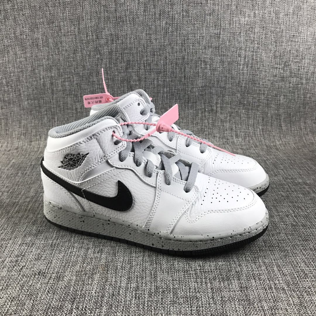 Pair of white and black high-top Jordan sneakers shown from a front three-quarter angle.