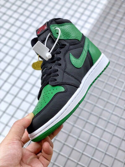 Angled close-up of the black and green upper, perforated toe, laces, and side swoosh.
