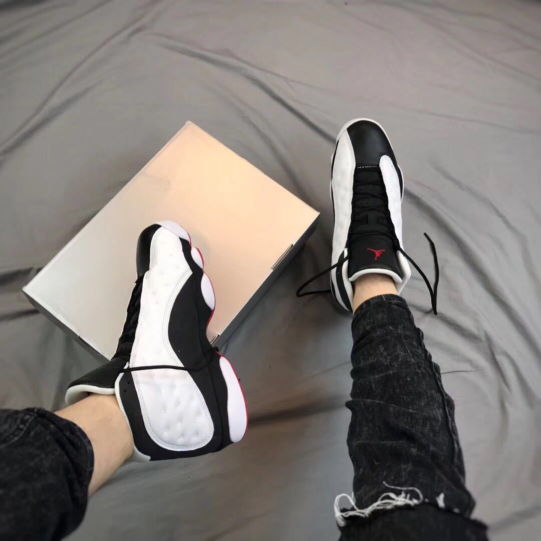 Lifestyle view of the sneakers being worn beside an open shoebox.