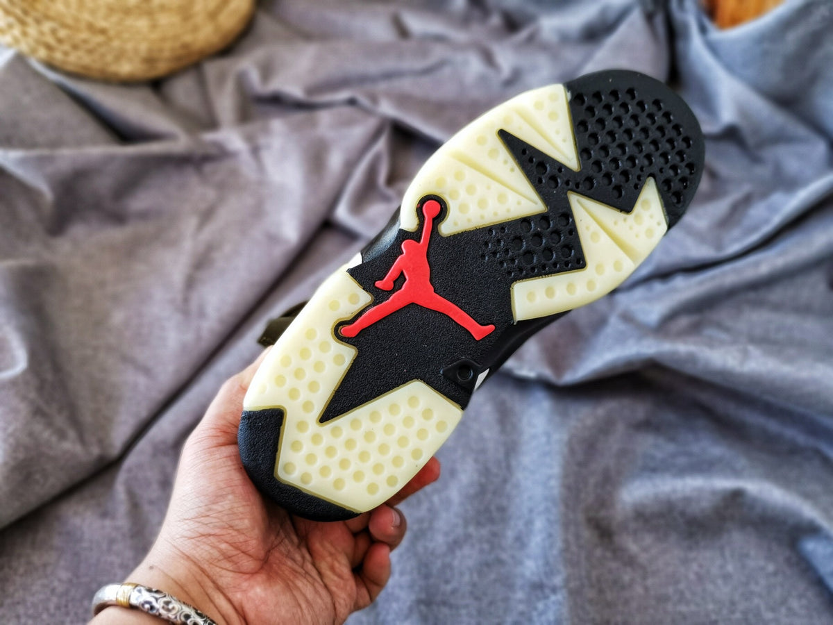 Outsole view showing the black traction sections, translucent rubber areas, and red Jordan logo.