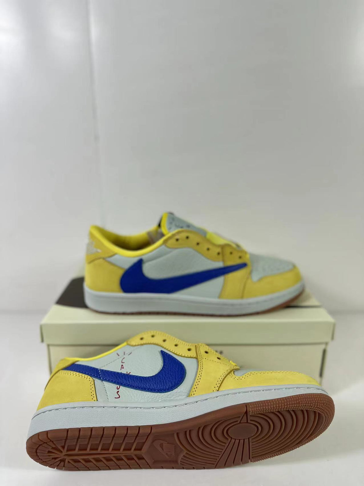Angled view of the pair showing the blue Swoosh, perforated toe area and gum outsole.