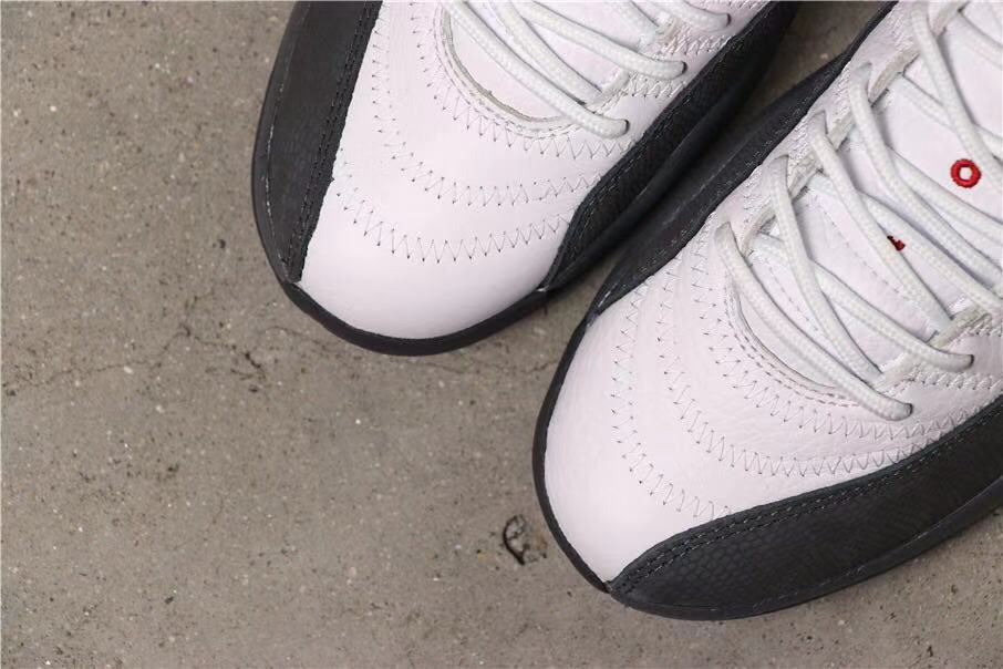 Close-up of the white toe boxes, white laces and dark grey overlays.