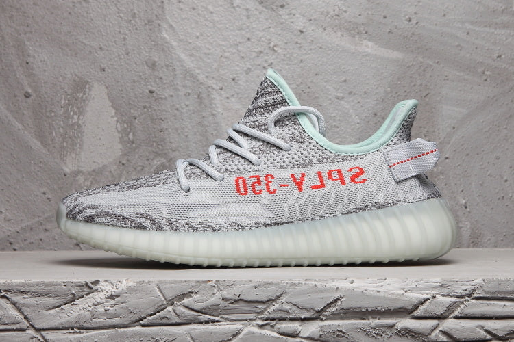 Side profile of the sneaker highlighting the gray patterned upper, red lettering, mint collar, and ribbed sole.