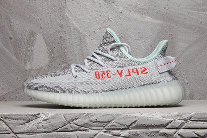 Side profile of the sneaker highlighting the gray patterned upper, red lettering, mint collar, and ribbed sole.