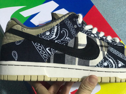 Close side view showing black patterned fabric, contrasting plaid panels, the dark Swoosh, and the textured outsole.