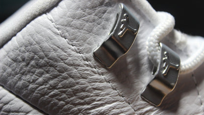 Close-up of the silver metal lace hardware with Jordan logos.