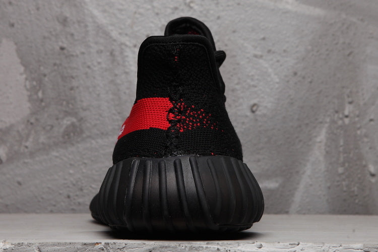 Rear view of the black sneaker showing the padded heel area and ribbed outsole.