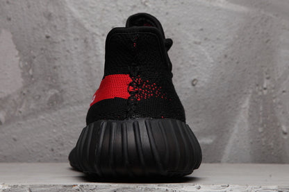 Rear view of the black sneaker showing the padded heel area and ribbed outsole.
