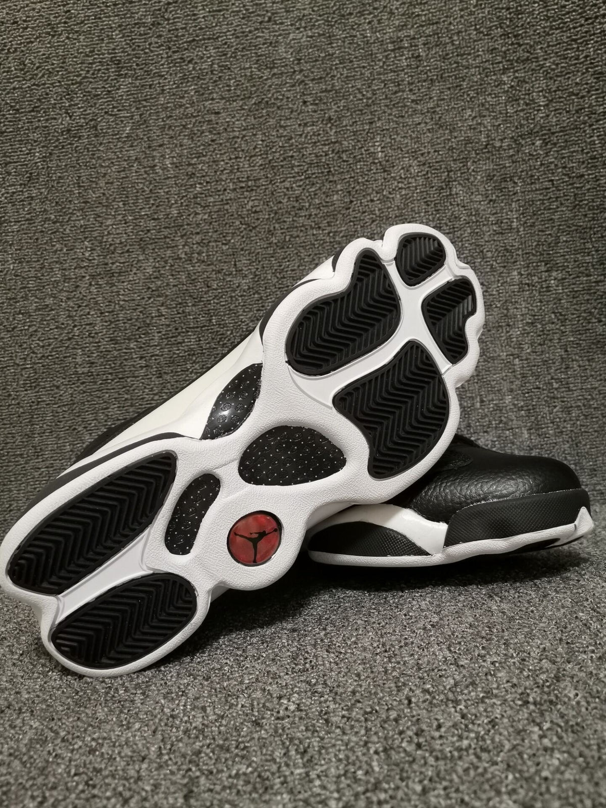 Outsole view showing black traction sections on a white base