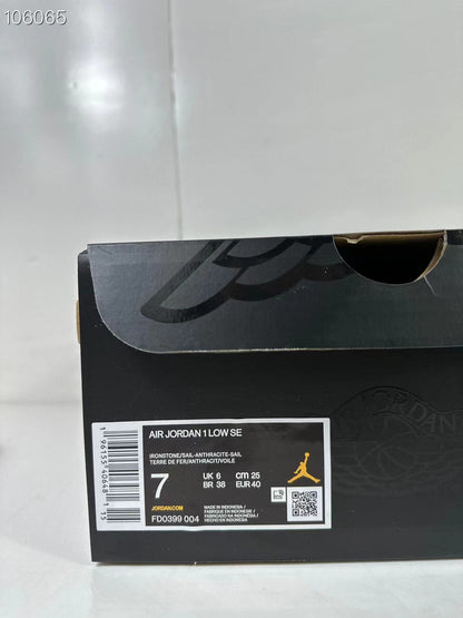 Black shoe box with a product label reading AIR JORDAN 1 LOW SE, style code FD0399 004, EU 40, UK 7 and CM 25.