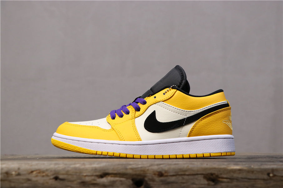 Side view of a yellow, white, and black Jordan low-top sneaker with purple laces, a black Swoosh, and yellow outsole tread.
