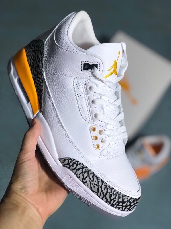 Angled view of a white Jordan 3-style sneaker with orange details and elephant-print overlay.