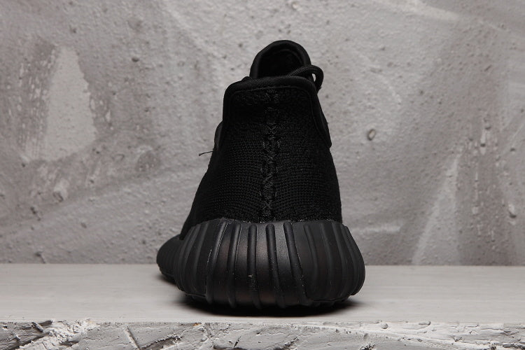 Rear view showing the black heel and vertically ribbed outsole of the sneaker.