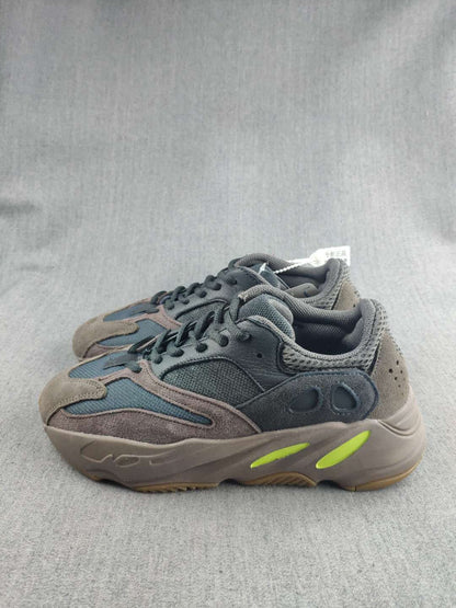 Pair of gray and blue 700 sneakers displayed at an angled side view.