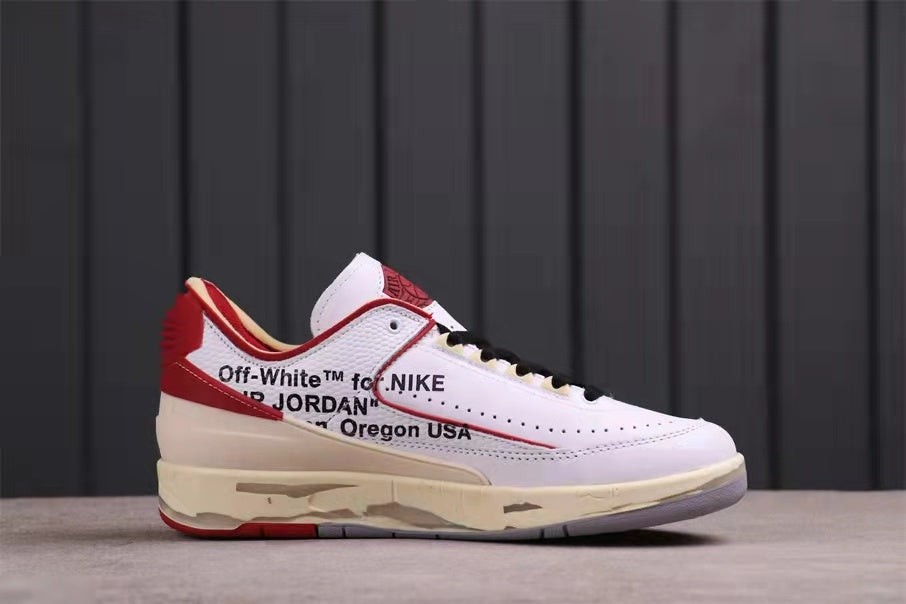 Side profile of the low-top sneaker with white panels, red trim, cream midsole, and printed lettering.