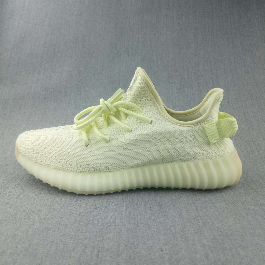 Side profile of the pale butter-yellow sneaker with a textured upper and ribbed sole.