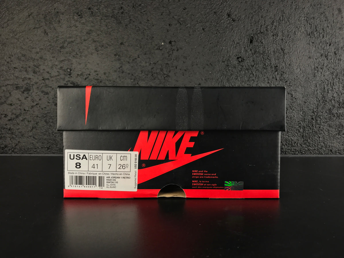 Nike shoebox with a visible size label showing USA 8, EURO 41, UK 7 and CM 26; the label identifies Air Jordan 1 Retro High OG.