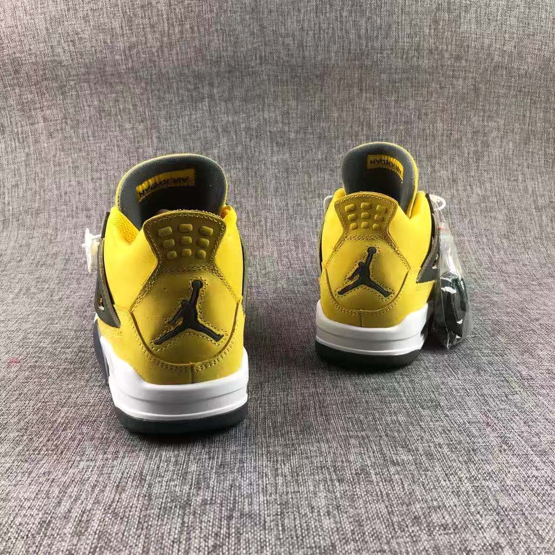 Rear view of the pair showing the heel Jumpman emblems, yellow collars, and white midsoles.